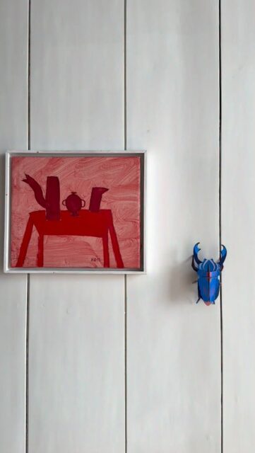 Azure stag beetle found its delicate shimmering spot next to an artwork at Romy & Ilyas home.